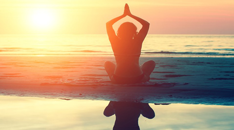 Meditation, serenity and yoga practicing at sunset.