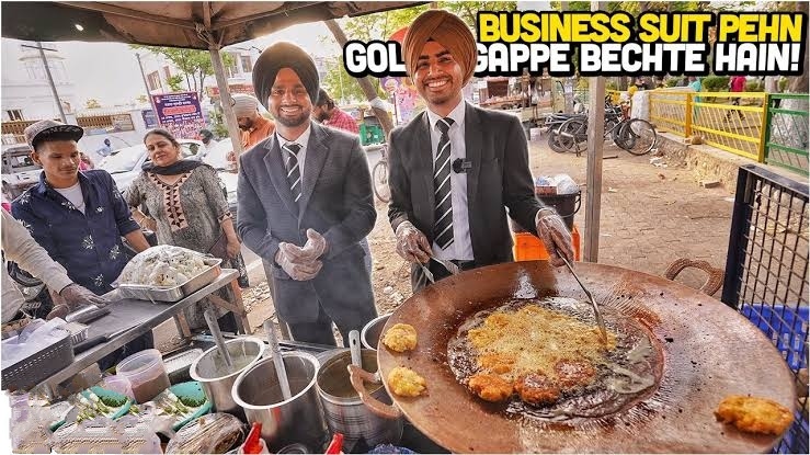 two sikh brothers selling indian street food in Mohali wearing business suits 